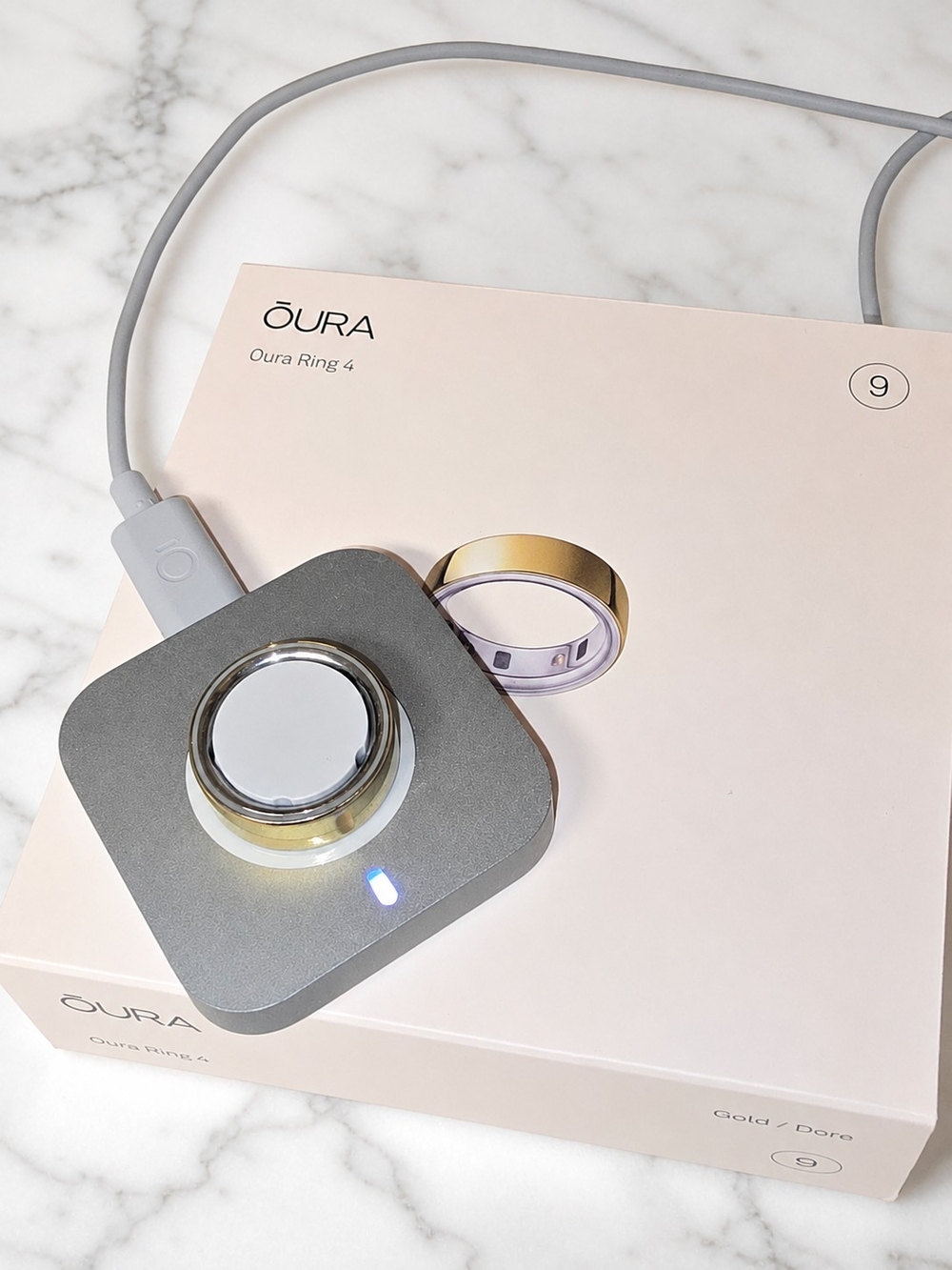 Oura Ring 4 Gold Ring with Gray Charger